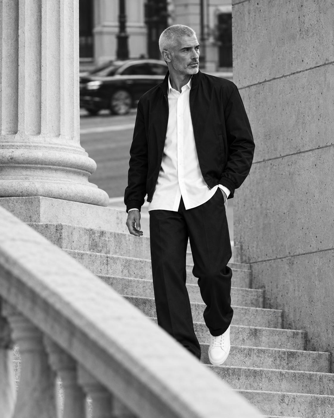 Black and white tailoring descending a monumental stone stair