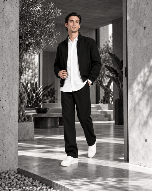 Authority Without a Lapel entering a planted brutalist residence