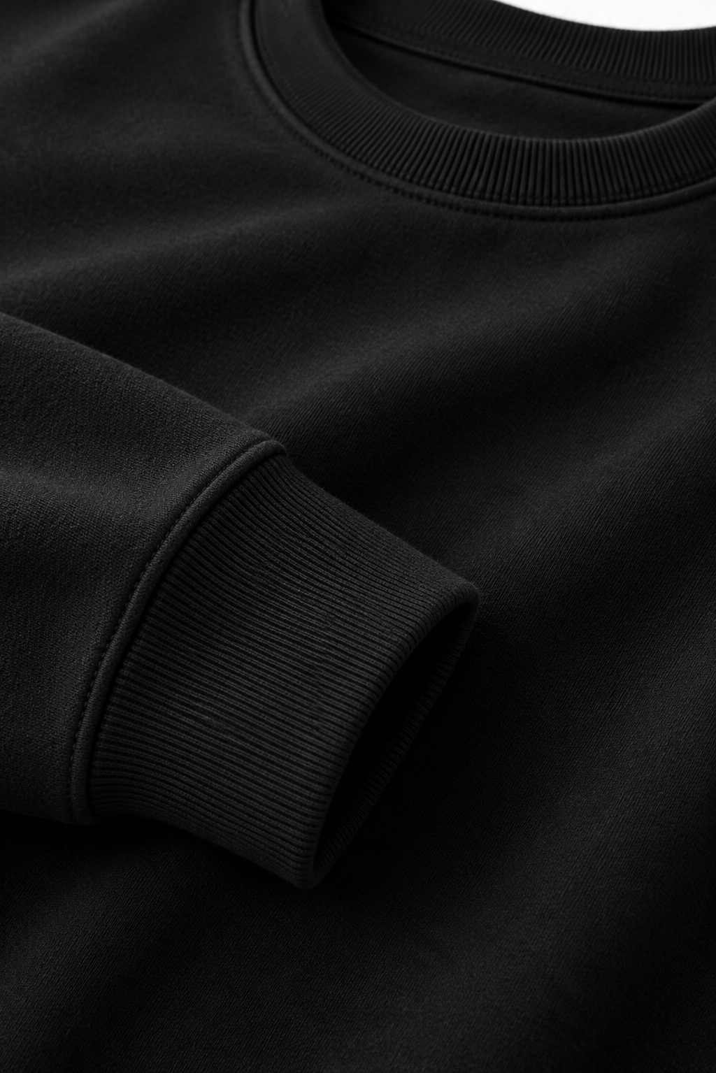 Close-up of black 530 GSM cotton crewneck fabric, neckline and ribbed cuff