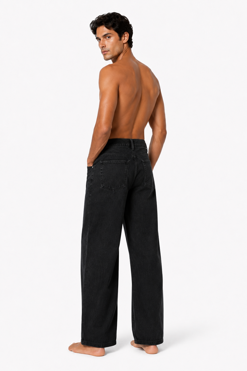 Shirtless barefoot male model wearing BUTTON-FRONT WIDE-LEG DENIM 001 by A. Manso, rear view