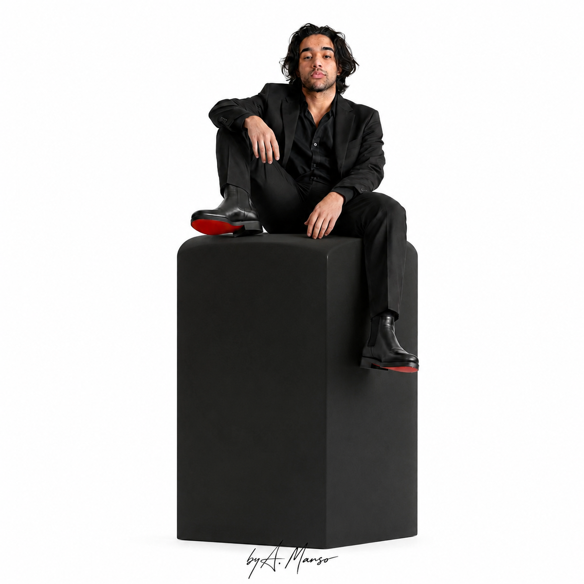 A. Manso seated on a monumental black sculptural pedestal