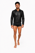 Male model wearing CROPPED LEATHER JACKET 000 with very short black lycra shorts and bare feet — front view