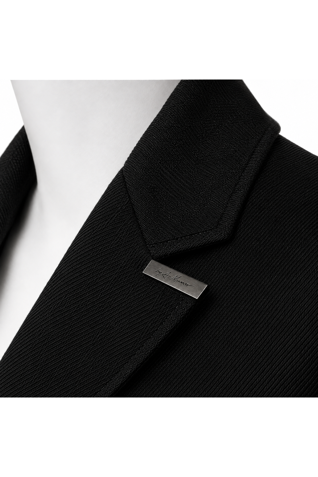 LONG COMMAND COAT 000 — engraved A. Manso signature brooch detail