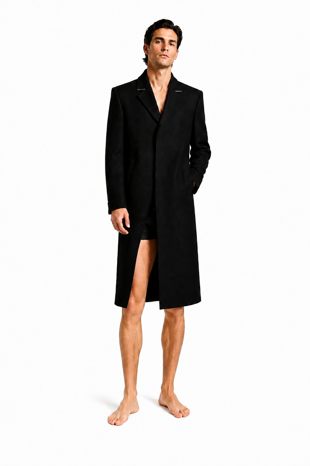 Male model wearing LONG COMMAND COAT 000 with very short black lycra shorts and bare feet — front view
