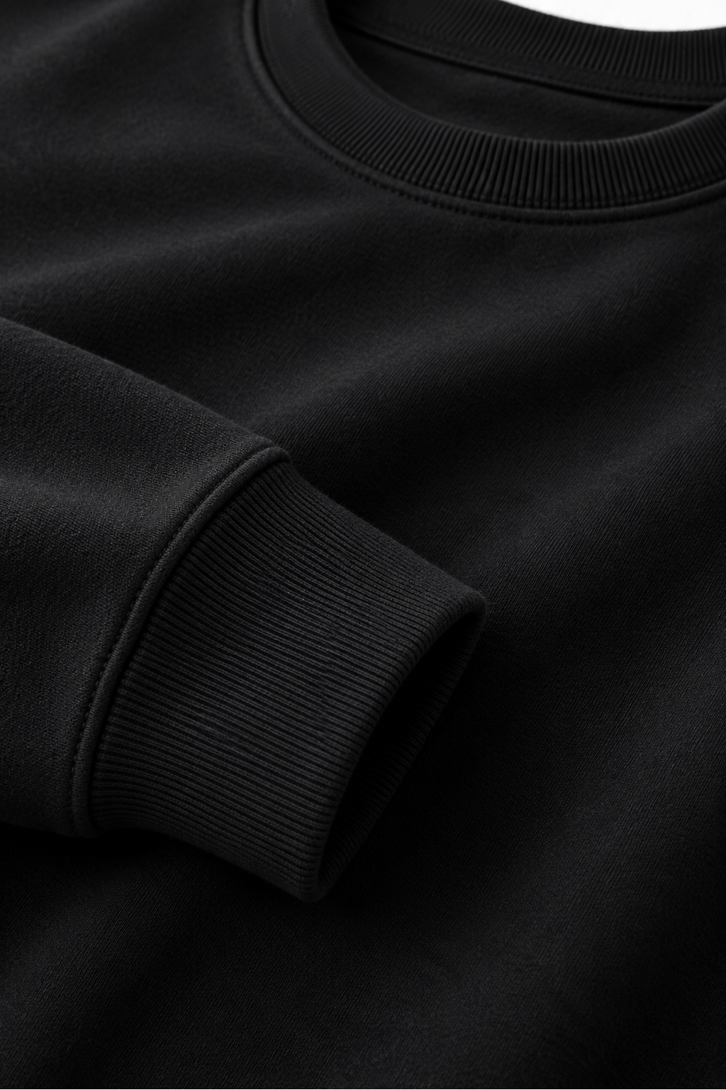 Close-up of black 530 GSM cotton crewneck fabric, neckline and ribbed cuff