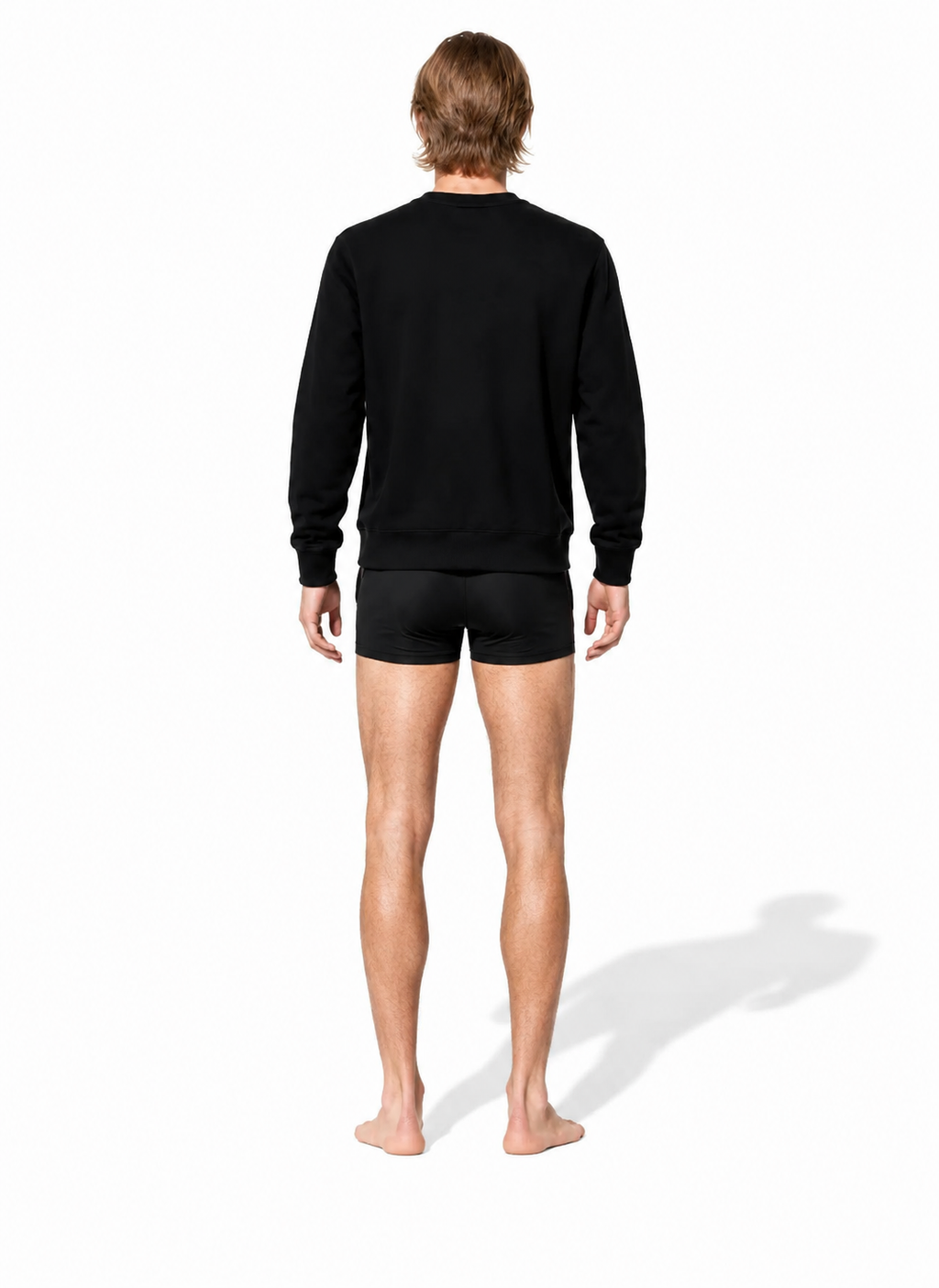 THE 530 OBSIDIAN BLACK COTTON CREWNECK 001 on barefoot male model in short black lycra — back view